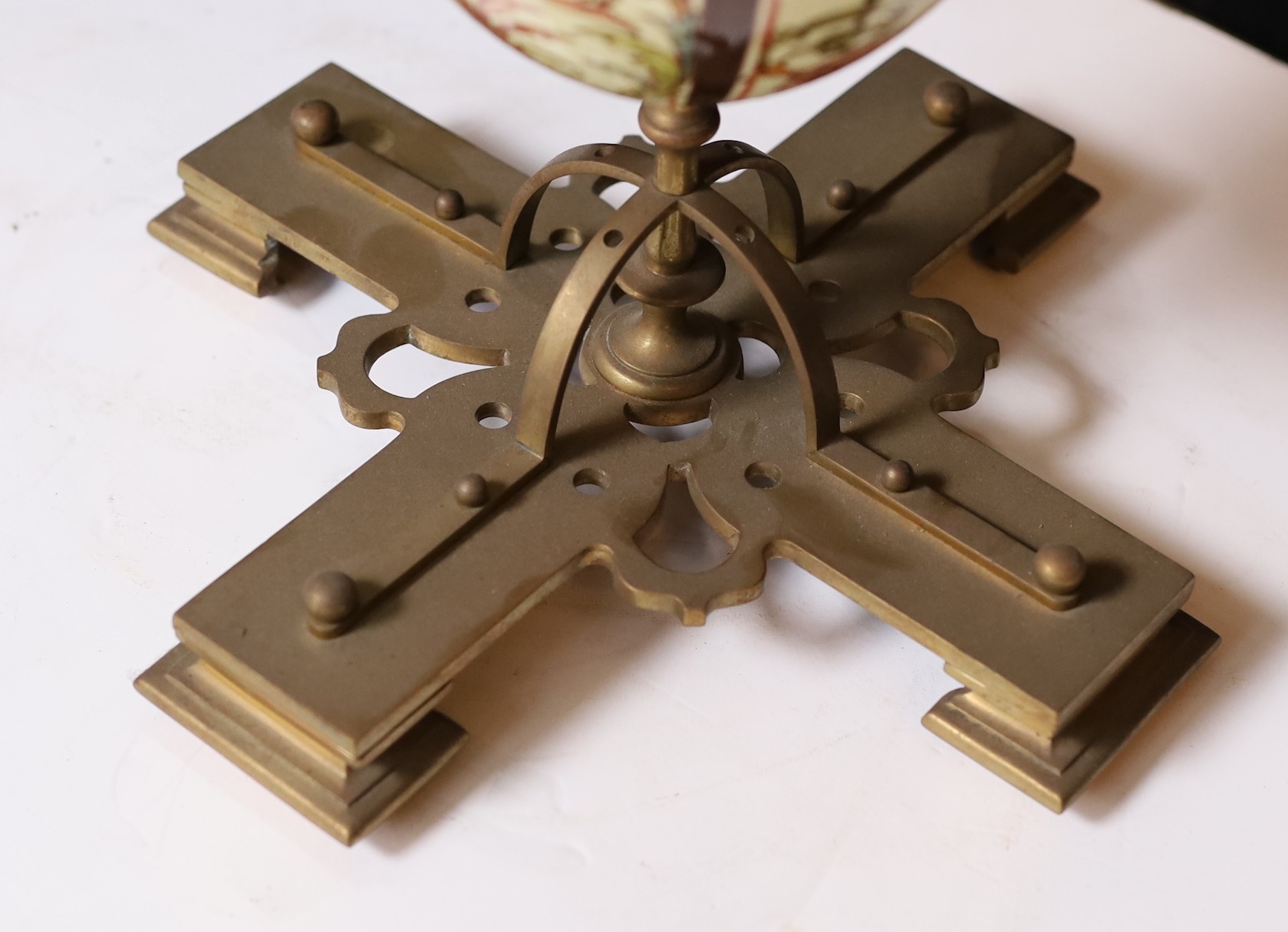 A Victorian brass mounted ceramic oil lamp in the manner of Dalton with brass reservoir and frosted glass shade decorated with birds, height overall 64cm